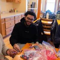 three students at table bagging food